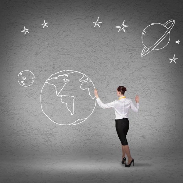 Businesswoman presenting drawn planet — Stock Photo, Image