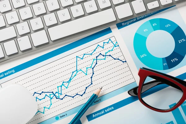 Lugar de trabajo con teclado y diagramas — Foto de Stock