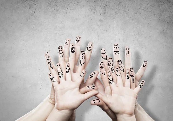 Family hands with cartoon faces — Stock Photo, Image