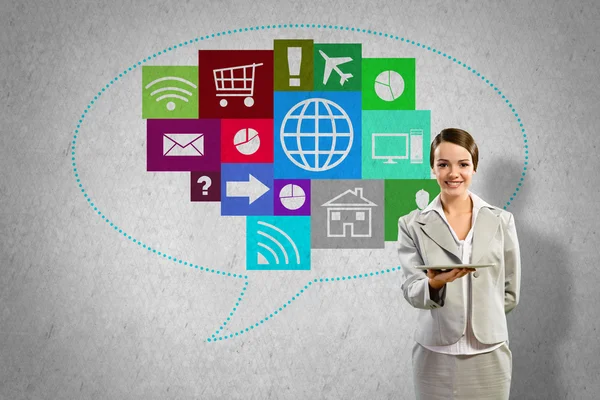 Businesswoman presenting tablet pc and color icons — Stock Photo, Image