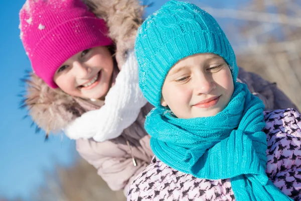 Two cute girls riding sled — Stock Photo, Image