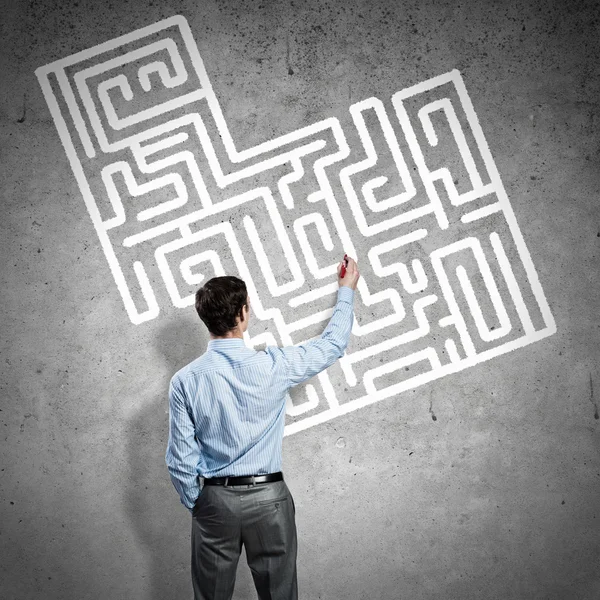 Empresario dibujando laberinto en la pared — Foto de Stock