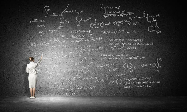 Woman drawing formulas — Stock Photo, Image