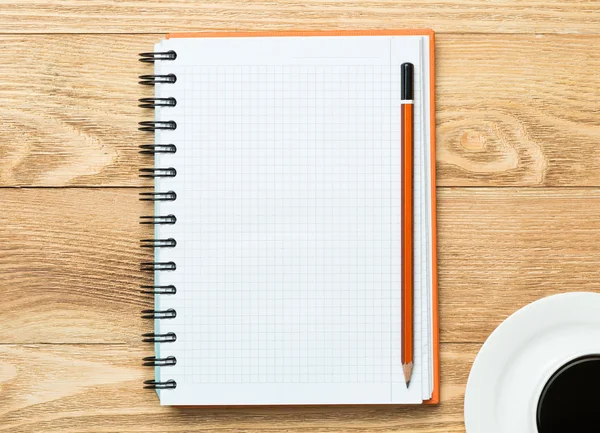 Notepad with cup of coffee and pencil — Stock Photo, Image