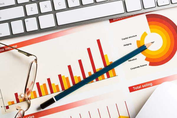 Business workplace with keyboard and diagrams