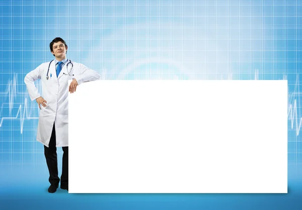 Doctor with white blank banner — Stock Photo, Image