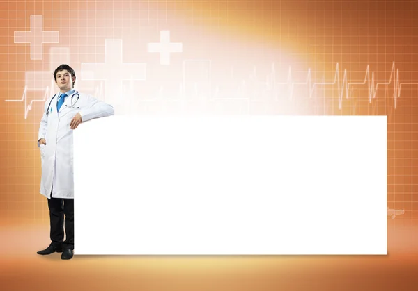 Doctor with white blank banner — Stock Photo, Image