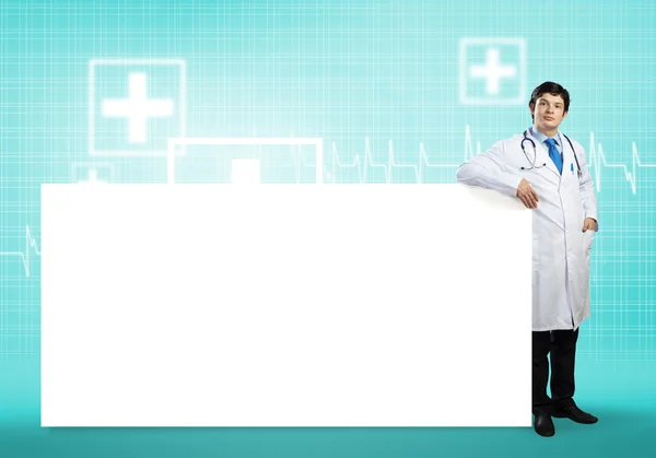 Doctor with white blank banner — Stock Photo, Image