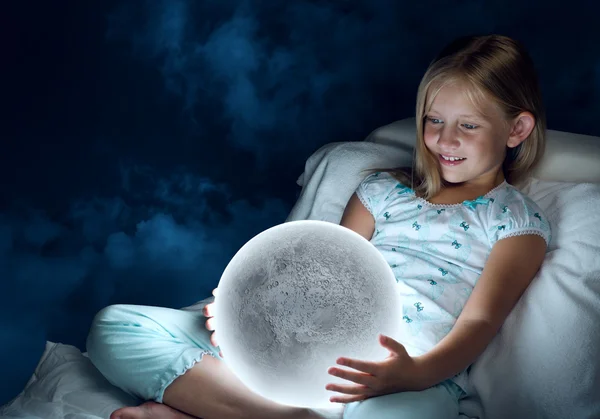 Girl in her bed and moon planet — Stock Photo, Image