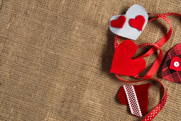 Handmade love hearts on brown clothing — Stock Photo, Image