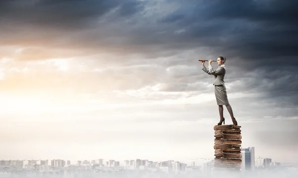 Career woman on pile of books — Stock Photo, Image