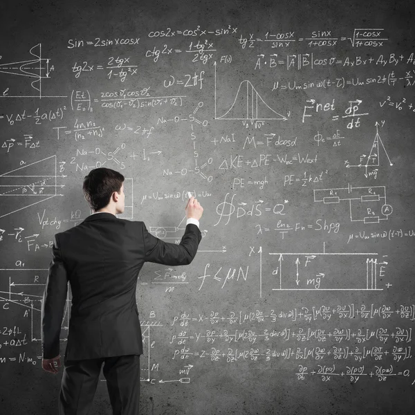 Man writing on blackboard — Stock Photo, Image