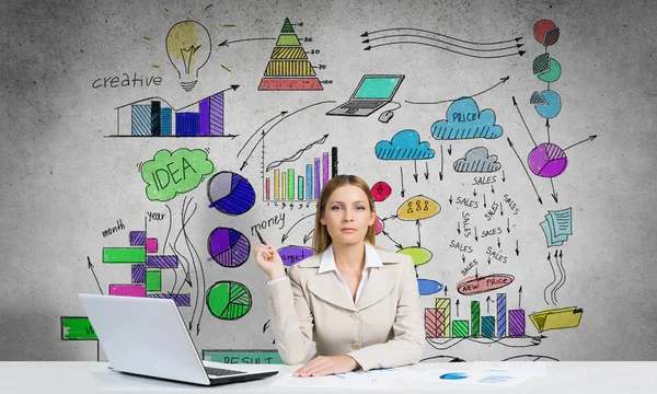 Elegant businesswoman sitting at table — Stock Photo, Image