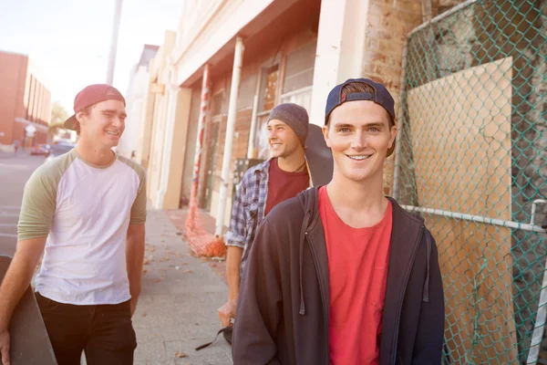 Positive teenage friends with skateboards — Stock Photo, Image