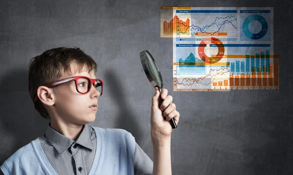Boy looking through magnifying glass — Stock Photo, Image