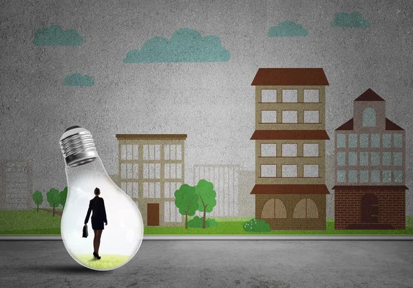 Businesswoman trapped in bulb — Stock Photo, Image