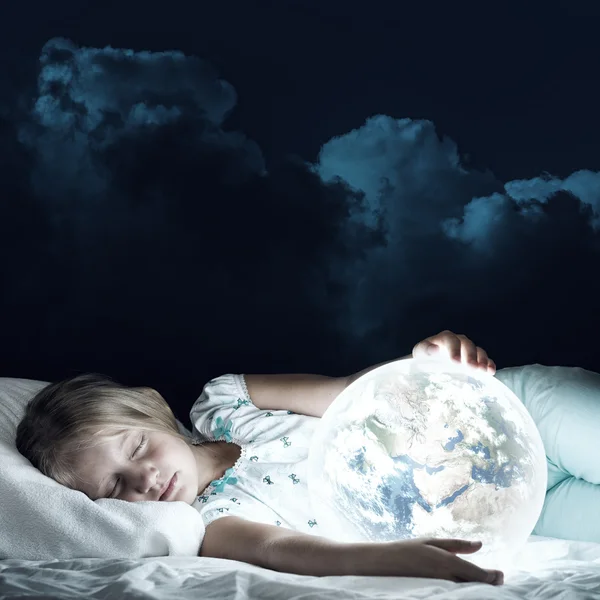 Girl in bed and looking at Earth planet — Stock Photo, Image