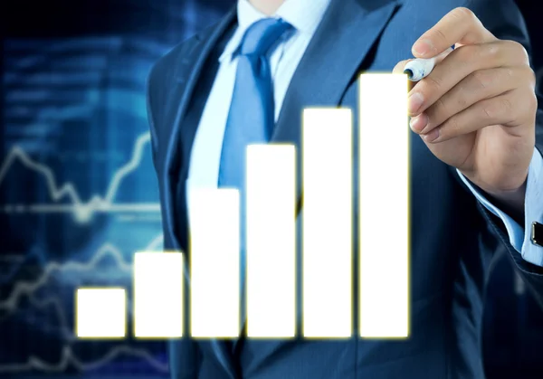 Businessman drawing on growing graph — Stock Photo, Image