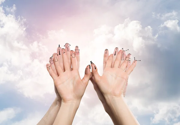 Hands of man and woman on clouds background — Stock Photo, Image