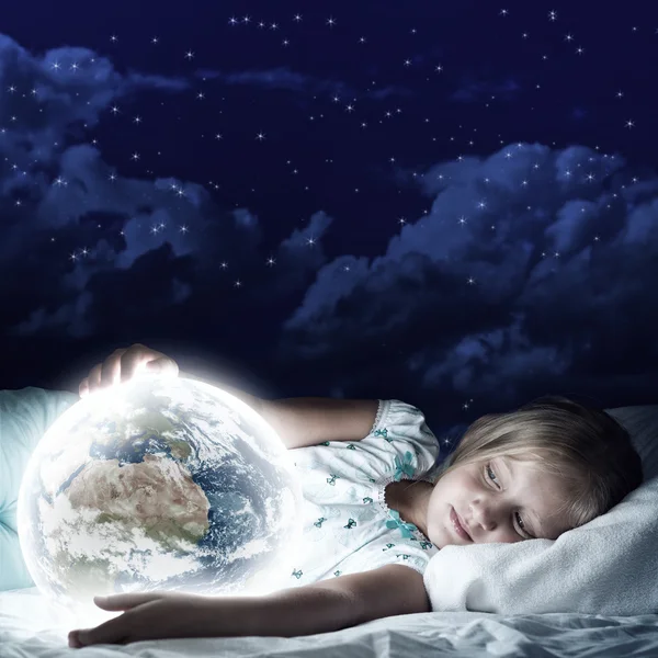 Girl in bed and looking at Earth planet — Stock Photo, Image