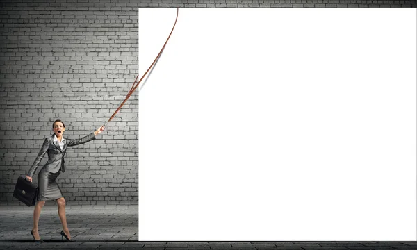 Young businesswoman pulling white banner — Stock Photo, Image