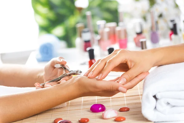 Kvinde i salon modtager manicure - Stock-foto