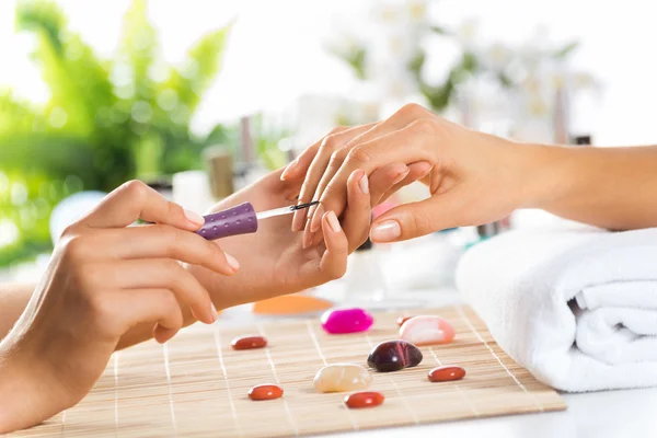 Woman in salon receiving manicure — Stock Photo, Image