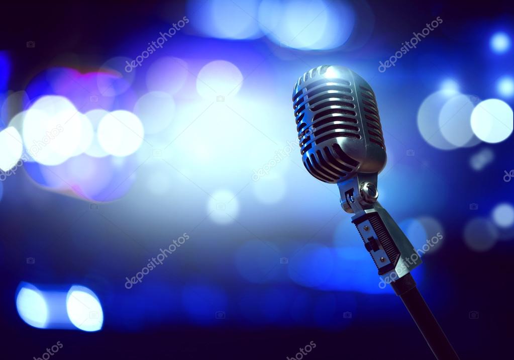 Microphone on stage background Stock Photo by ©Khakimullin 119991696