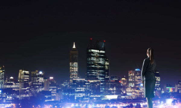 Woman looking at night city