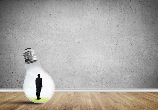 Businessman trapped in bulb — Stock Photo, Image