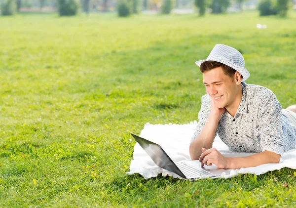 Young man working in park — Stock Photo, Image