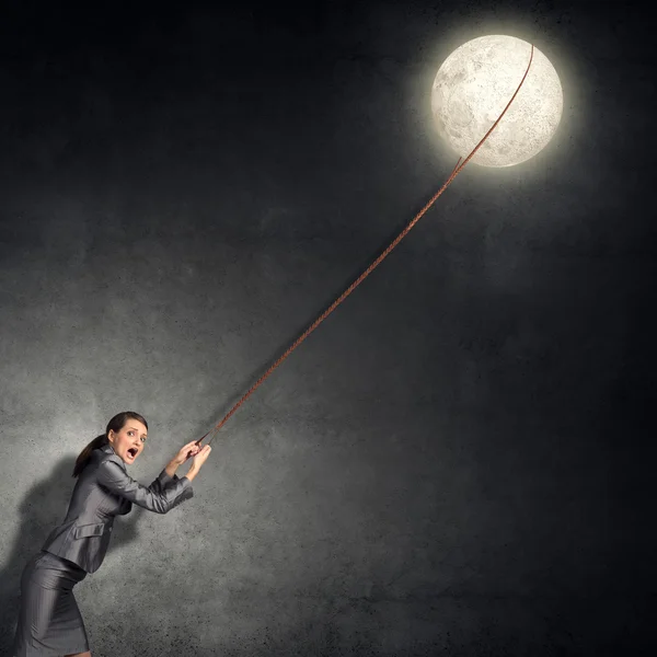 Young woman holding moon planet — Stockfoto