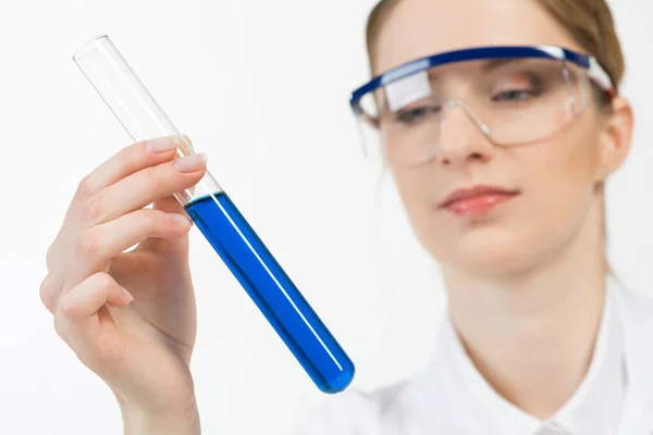 Beautiful woman scientist in protective goggles — Stock Photo, Image