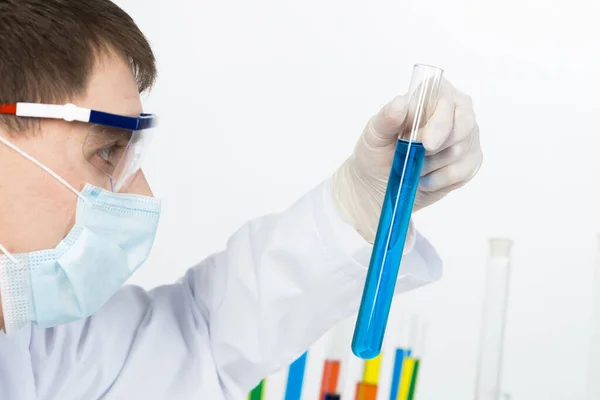 Laboratory technician in safety mask and gloves