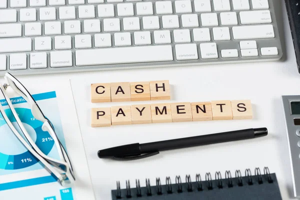 Cash payments concept with letters on cubes