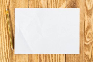 Kağıt çarşaflı düz tahta bir masa.