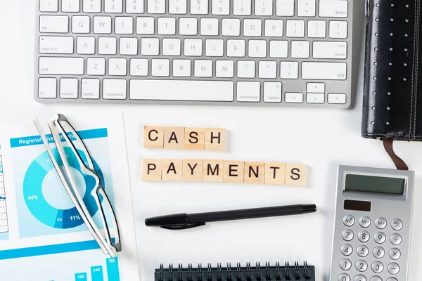 Cash payments concept with letters on cubes