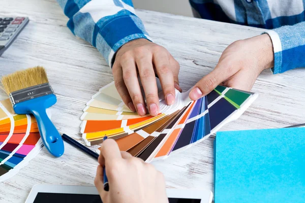 Interior designer choosing colors from swatches