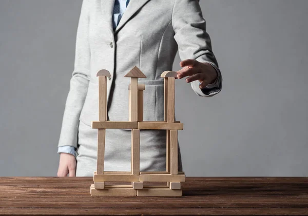 Business woman building tower on table — Stock Photo, Image