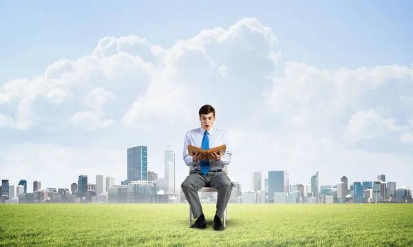 Young businessman with book — Stock Photo, Image