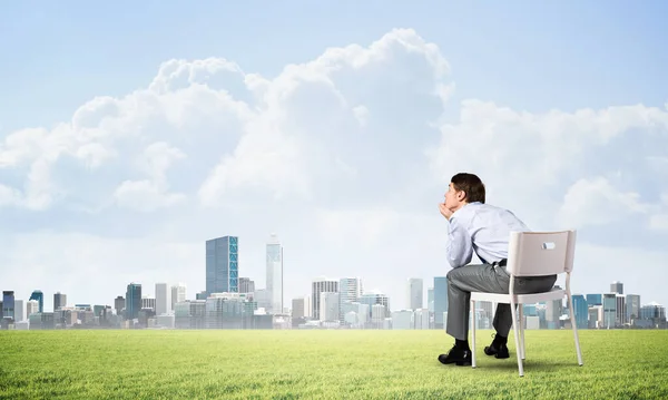 Young businessman sitting on an office chair — Stock Photo, Image