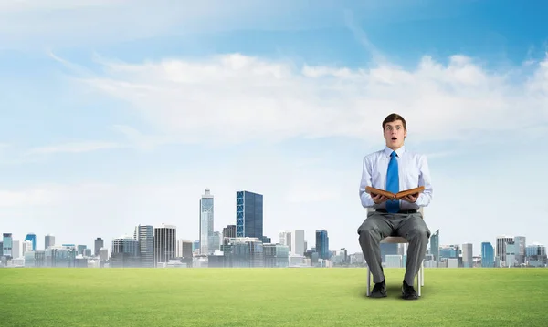 Young businessman with book — Stock Photo, Image