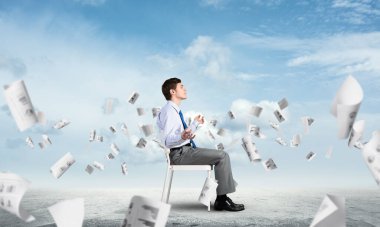 İş adamı ofis sandalyesinde meditasyon yapıyor.