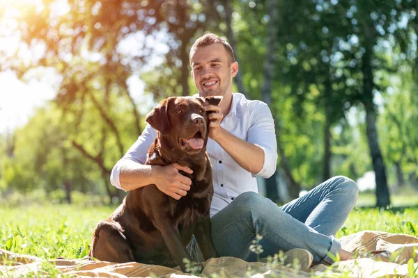 Junger Mann mit Hund im Park — Stockfoto