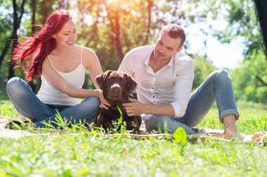 Parkta köpeği olan çift.