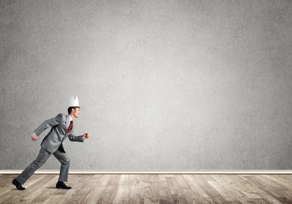 King businessman in elegant suit running in empty room — Stock Photo, Image