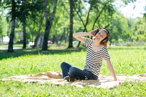 Bir yaz parkında müzik çalan genç bir kadın. — Stok fotoğraf