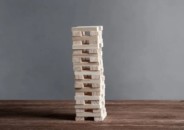 Tower from wooden blocks standing on table
