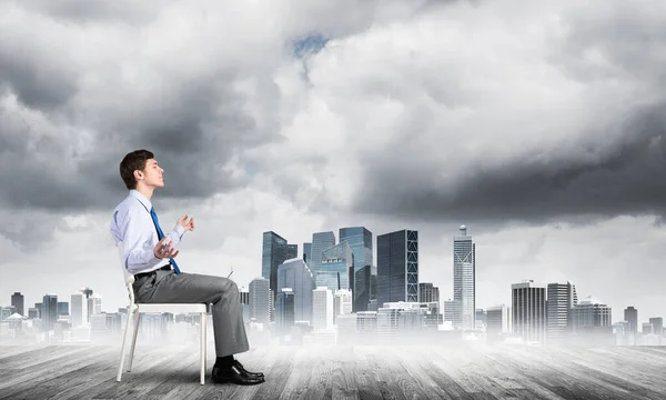 Businessman meditates on office chair — Stock Photo, Image