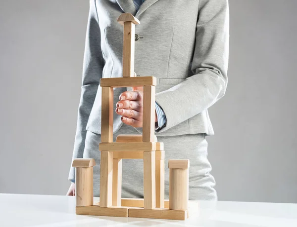 Business woman building tower on table — Stock Photo, Image